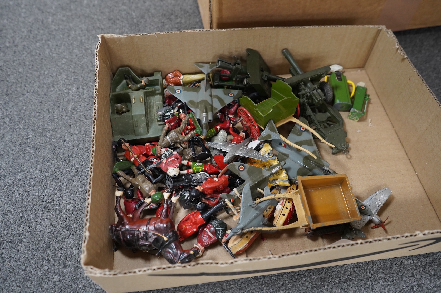 A collection of Britains military soldiers, etc, including two boxed Britains military field guns; an 18” Howitzer (No.2107), and a 155mm Gun (No.2064), both with some accessories and shells missing, an unboxed Bren Gun